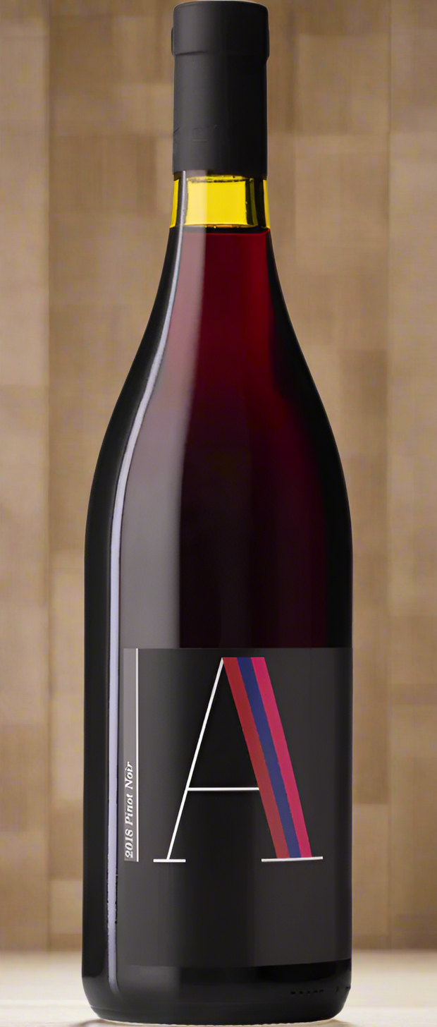 Red wine bottle with a black label featuring a stylized letter 'A' on a white background